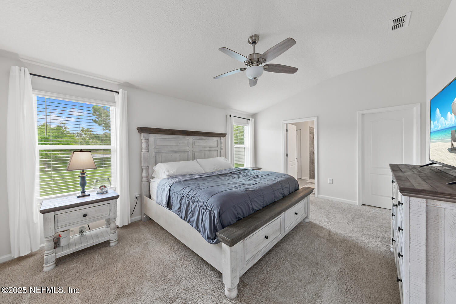 352 Chasewood Drive St. Augustine, FL 32095 - Photo 19 of 29 a spacious bedroom with a bed and a window