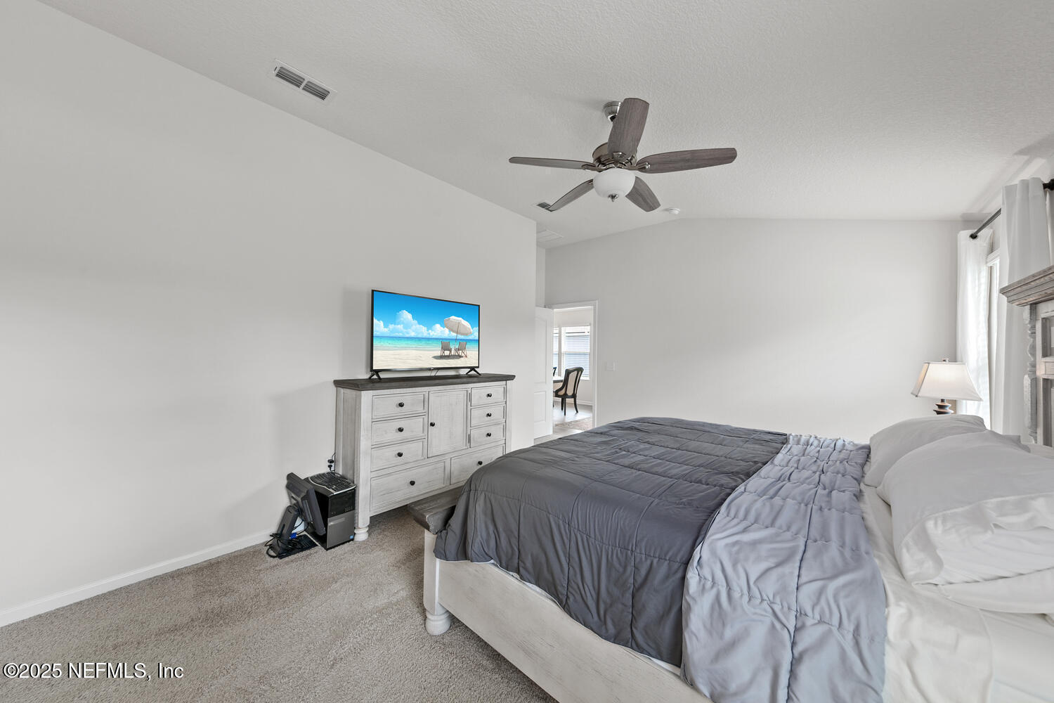 352 Chasewood Drive St. Augustine, FL 32095 - Photo 20 of 29 a bedroom with a bed and a tv on the dresser