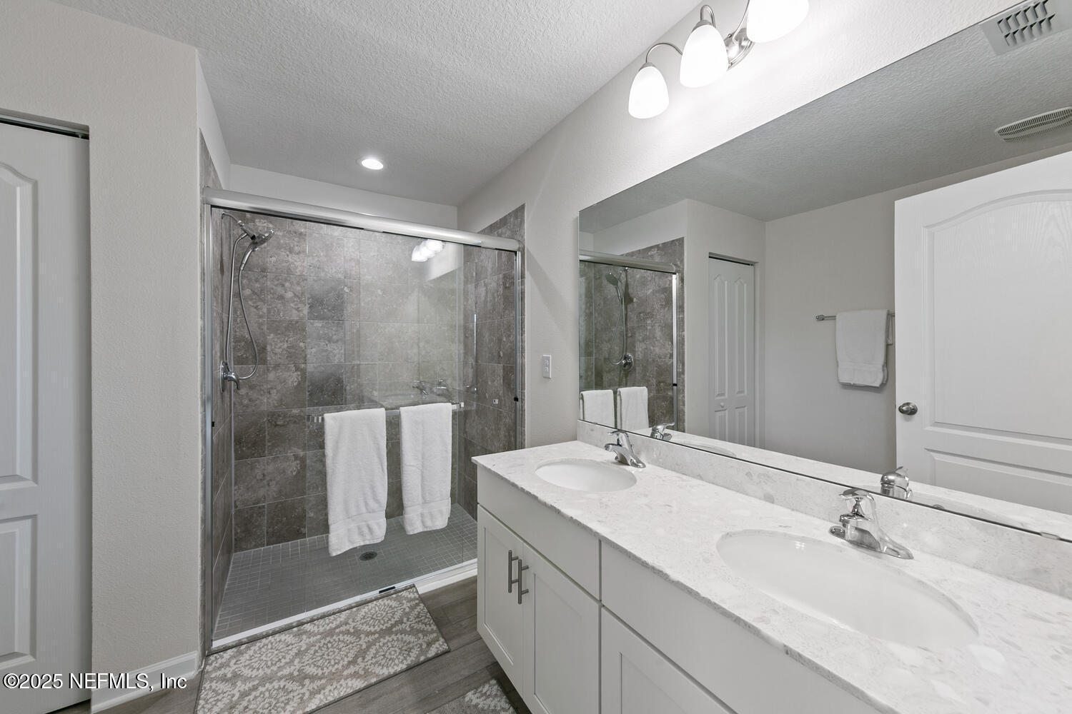 352 Chasewood Drive St. Augustine, FL 32095 - Photo 21 of 29 a bathroom with a double vanity sink mirror and shower