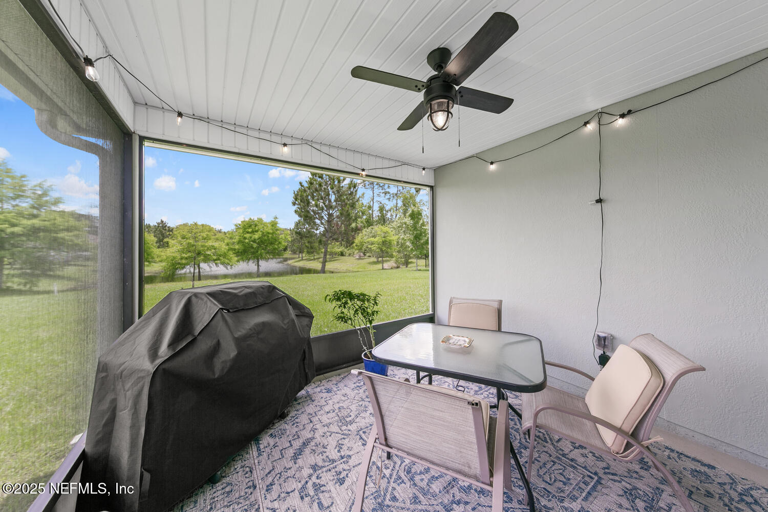 352 Chasewood Drive St. Augustine, FL 32095 - Photo 23 of 29 a living room with furniture and a floor to ceiling window