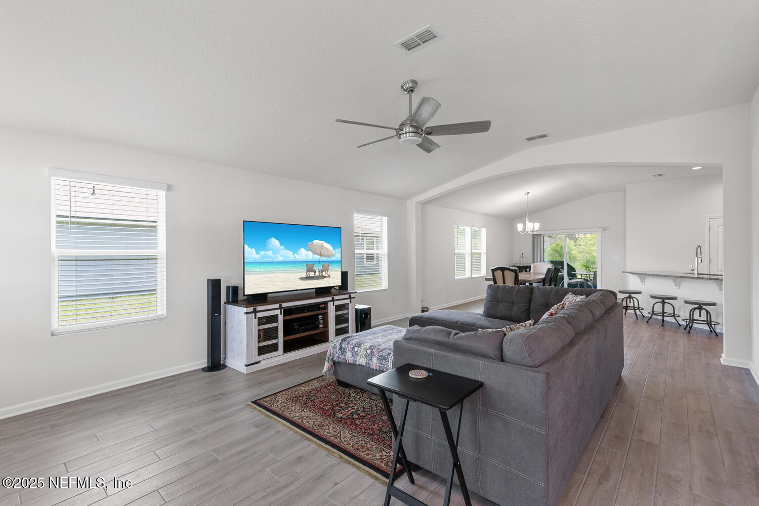 352 Chasewood Drive St. Augustine, FL 32095 - Photo 3 of 29 a living room with furniture a flat screen tv and a fireplace