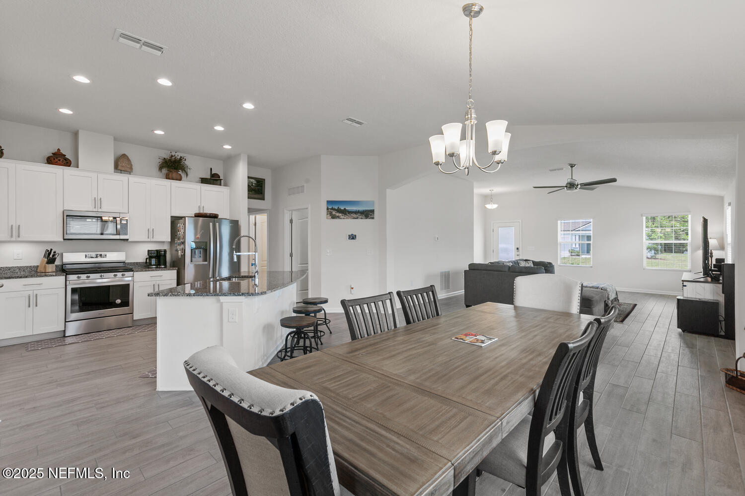 352 Chasewood Drive St. Augustine, FL 32095 - Photo 8 of 29 a view of a dining room and livingroom with furniture wooden floor a chandelier