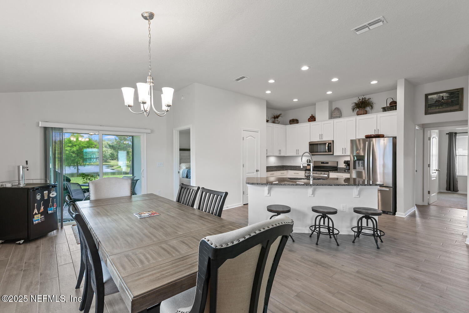 352 Chasewood Drive St. Augustine, FL 32095 - Photo 9 of 29 a view of a dining room and livingroom with furniture wooden floor a chandelier