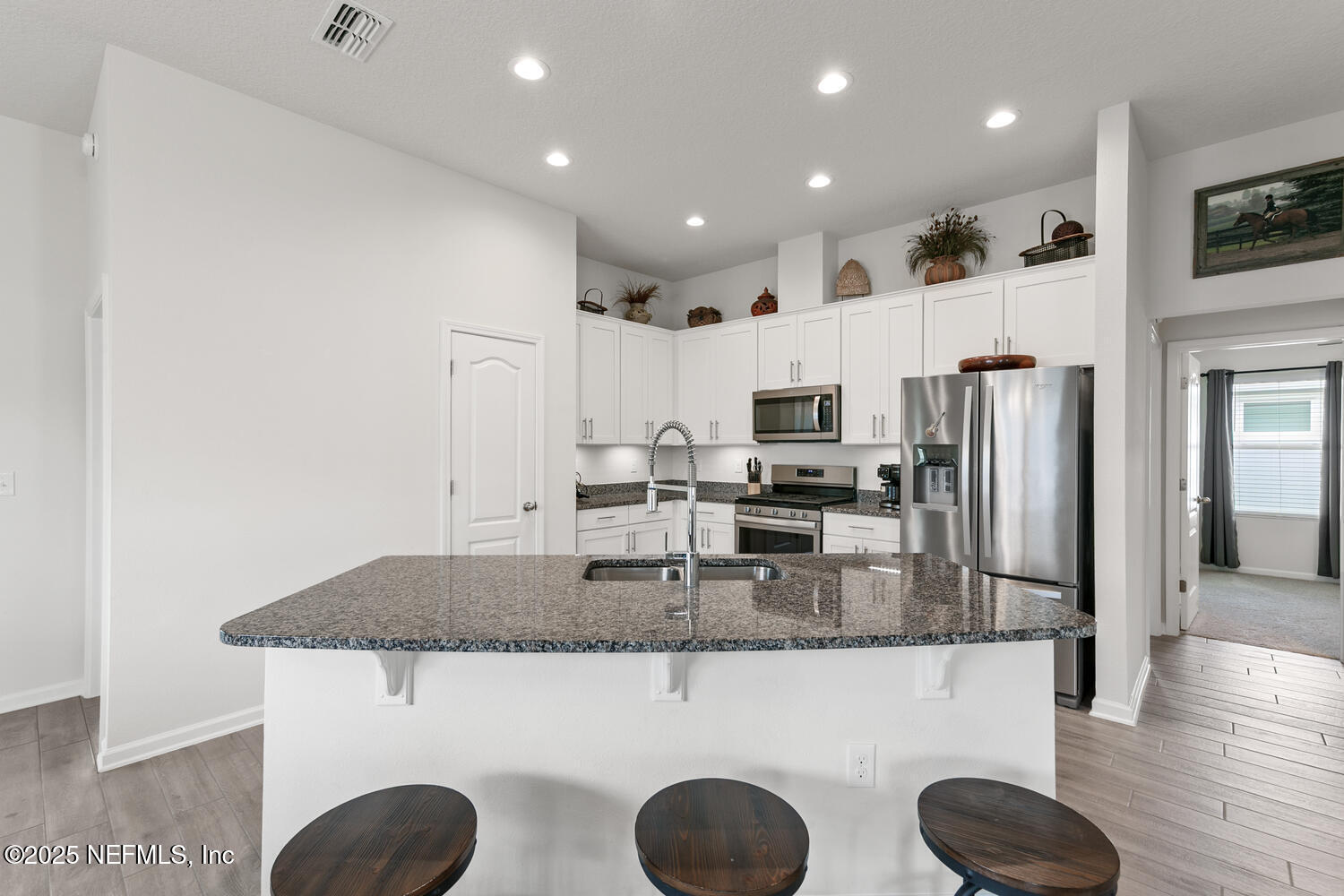 352 Chasewood Drive St. Augustine, FL 32095 - Photo 10 of 29 a kitchen with kitchen island granite countertop a stove a refrigerator a sink dishwasher with a dining table and chairs