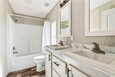 a bathroom with a sink a toilet and a bathtub