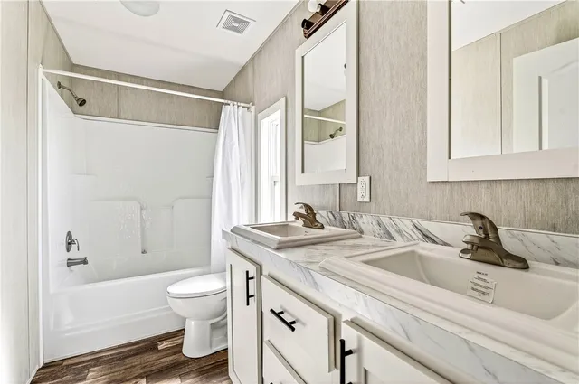 a bathroom with a sink a toilet and a bathtub