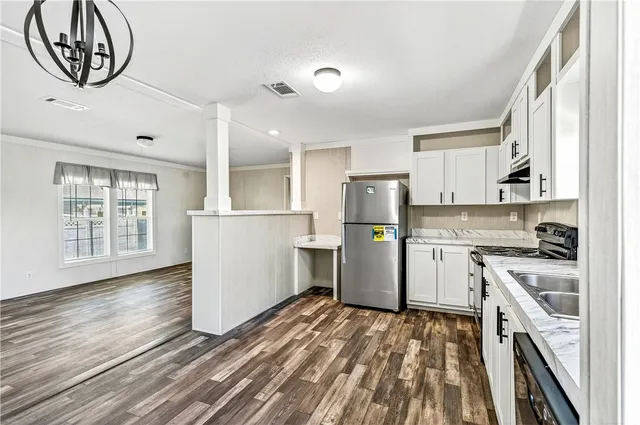 a kitchen with white cabinets and white appliances