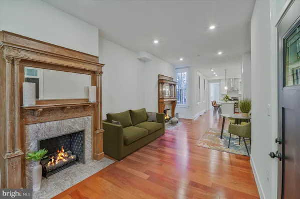 a living room with furniture and a fireplace