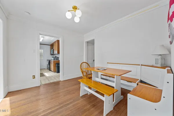 a room with furniture and view of kitchen