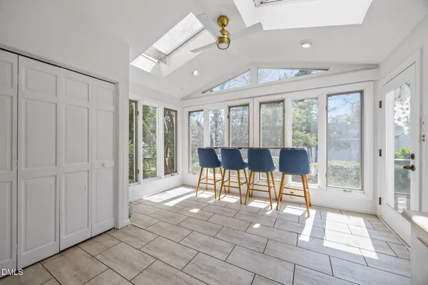a view of a livingroom with a dinning area wooden floor and windows