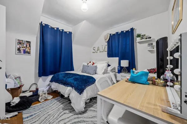 a bed room with a bed and a dresser