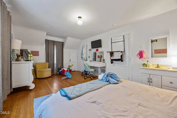 a bedroom with bed and a view of kitchen
