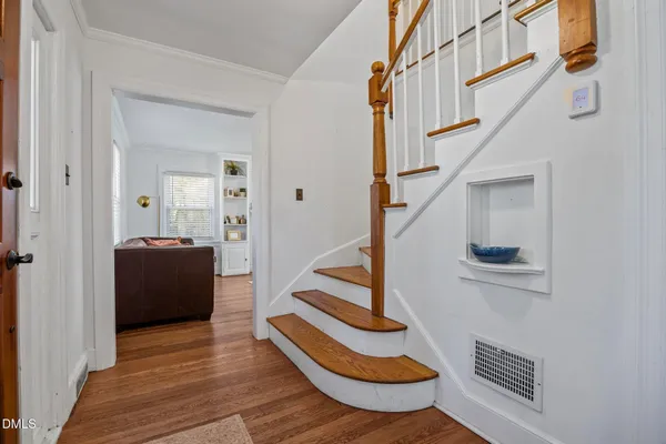 a view of entryway and hall with wooden floor