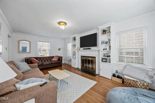 a living room with furniture a fireplace and a flat screen tv