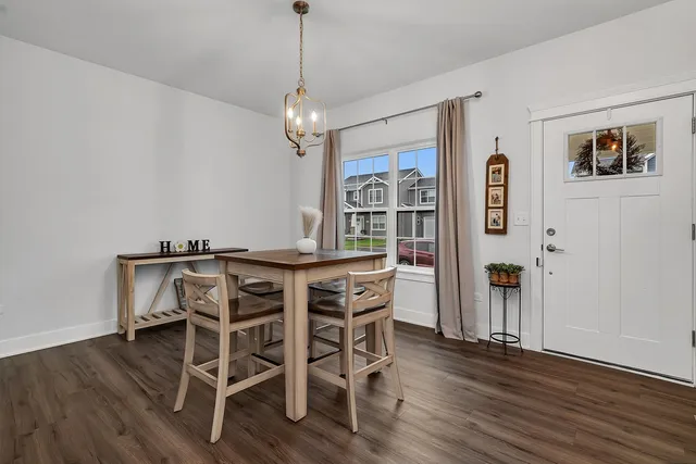 a view of a dining room with furniture wooden floor and chandelier