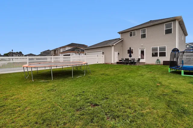 a swimming pool with outdoor seating and yard