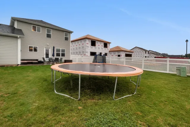 a view of a yard with a house and sitting space
