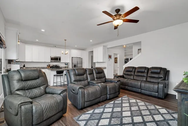 a living room with furniture and kitchen view