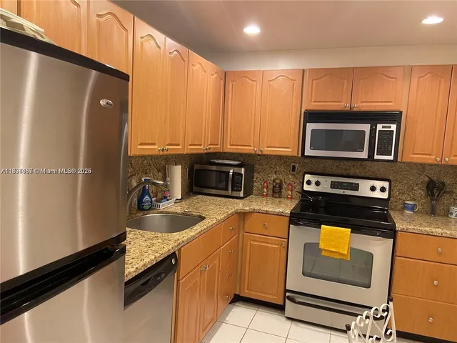 a kitchen with a refrigerator stove and microwave