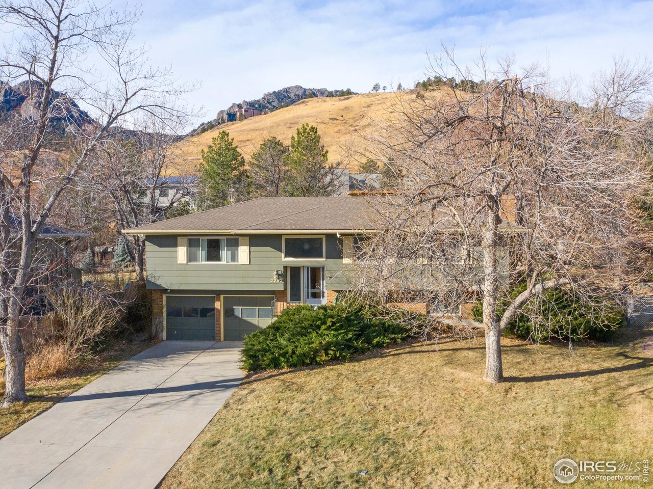 2287 Holyoke Drive Boulder, CO 80305 - Photo 37 of 40 a front view of a house with a yard and garage