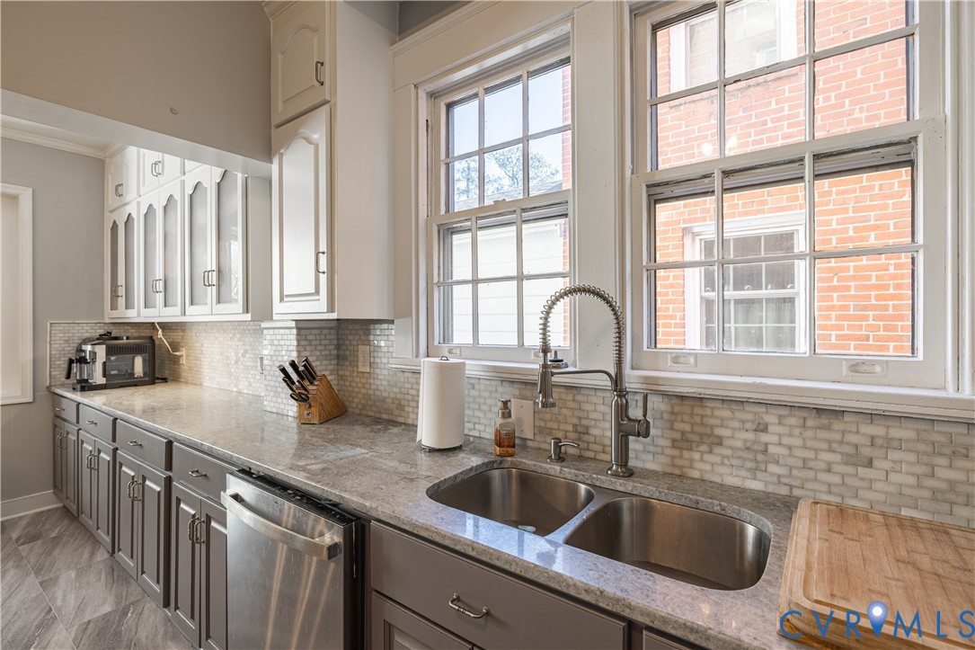 5013 Caledonia Road Richmond, VA 23225 - Photo 20 of 57 a kitchen with sink a window and cabinets