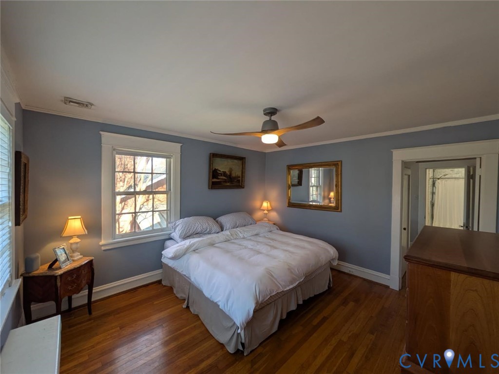5013 Caledonia Road Richmond, VA 23225 - Photo 25 of 57 a bedroom with a bed lamps and window