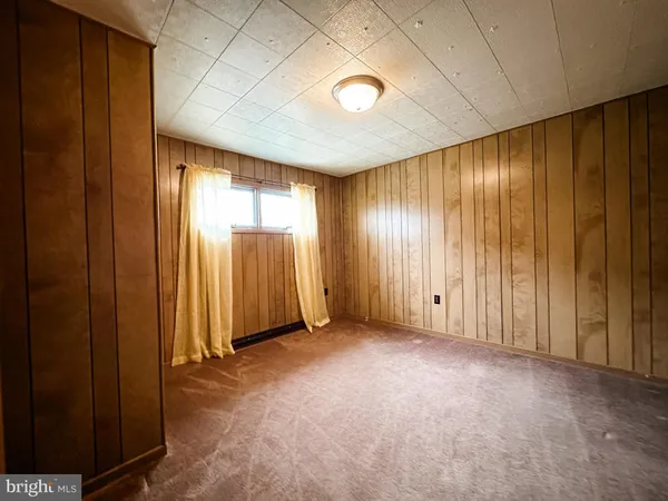 a view of an empty room with closet area