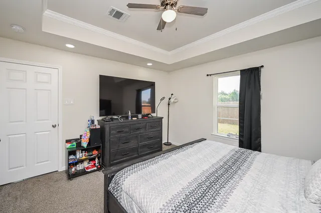 a bedroom with a bed and a flat screen tv