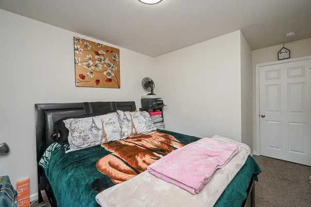 a bedroom with bed and a couch