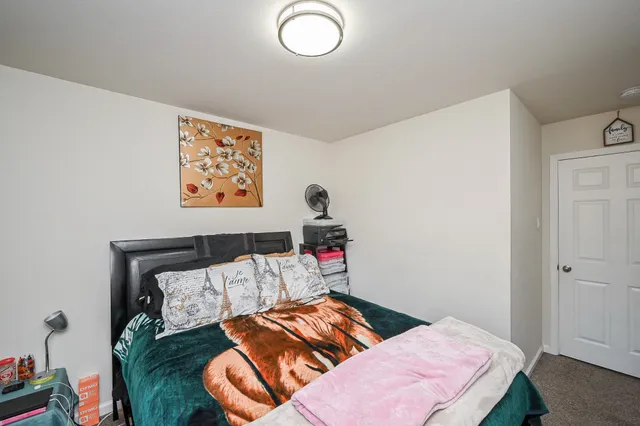 a bedroom with a bed and a couch