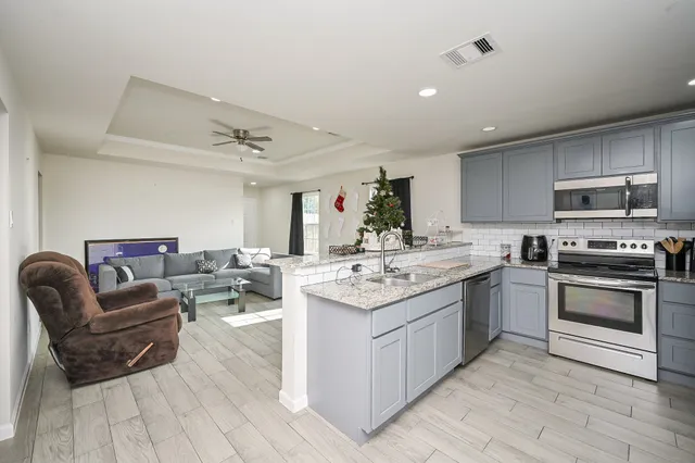 a kitchen with a sink stove and microwave