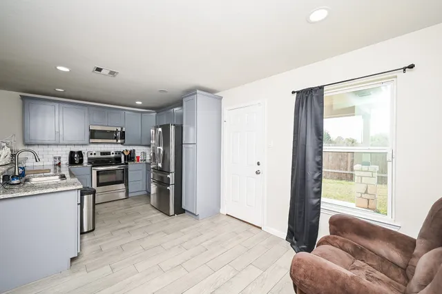 a kitchen with a refrigerator sink and microwave