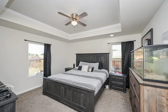 a bedroom with a large bed and a chandelier