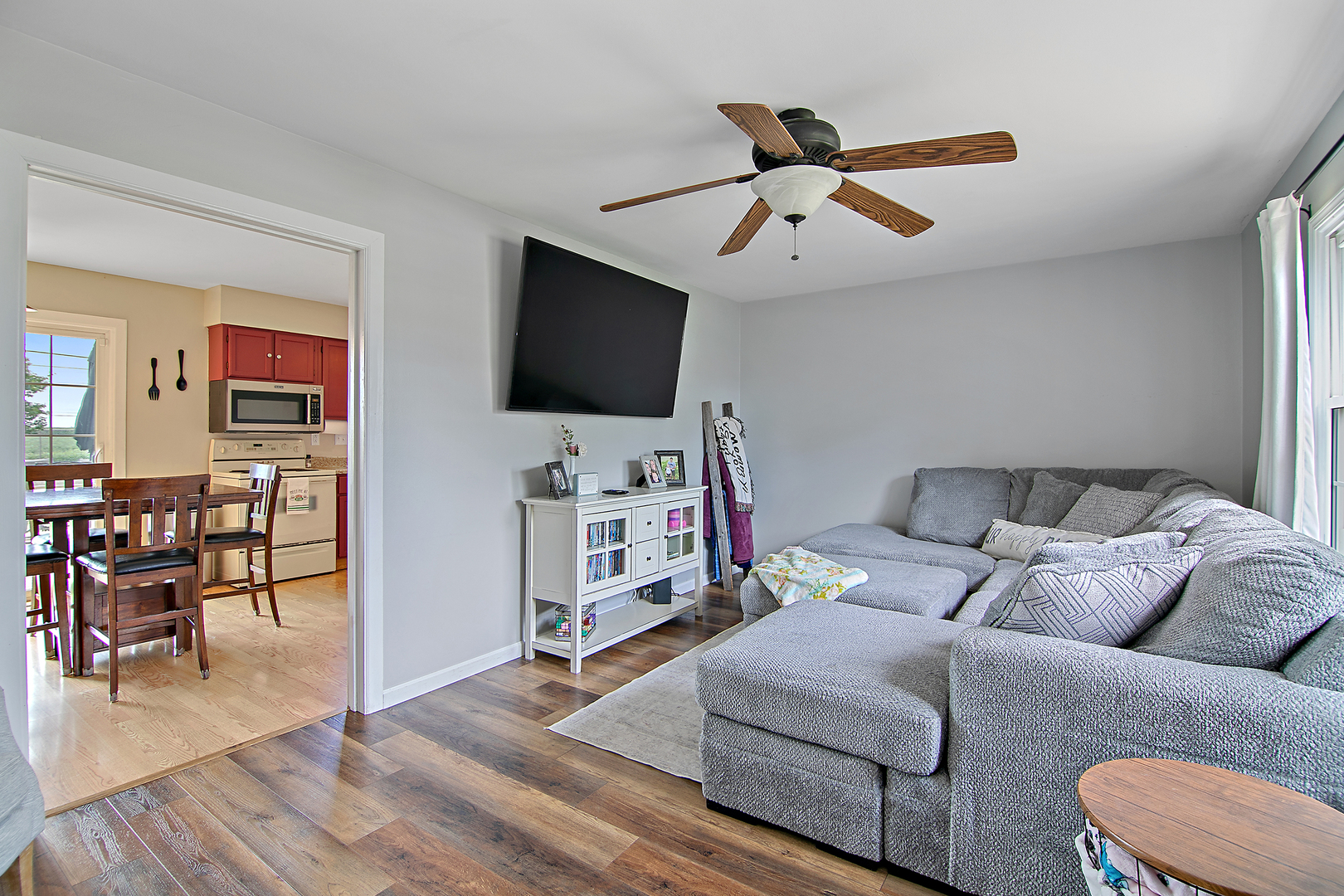 3494 El Paso Drive Kankakee, IL 60901 - Photo 6 of 20 a living room with furniture and a flat screen tv with wooden floor