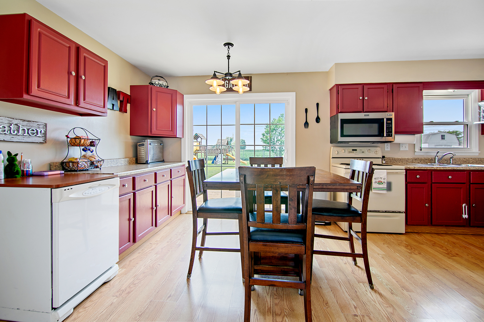 3494 El Paso Drive Kankakee, IL 60901 - Photo 7 of 20 a kitchen with a dining table chairs and white cabinets