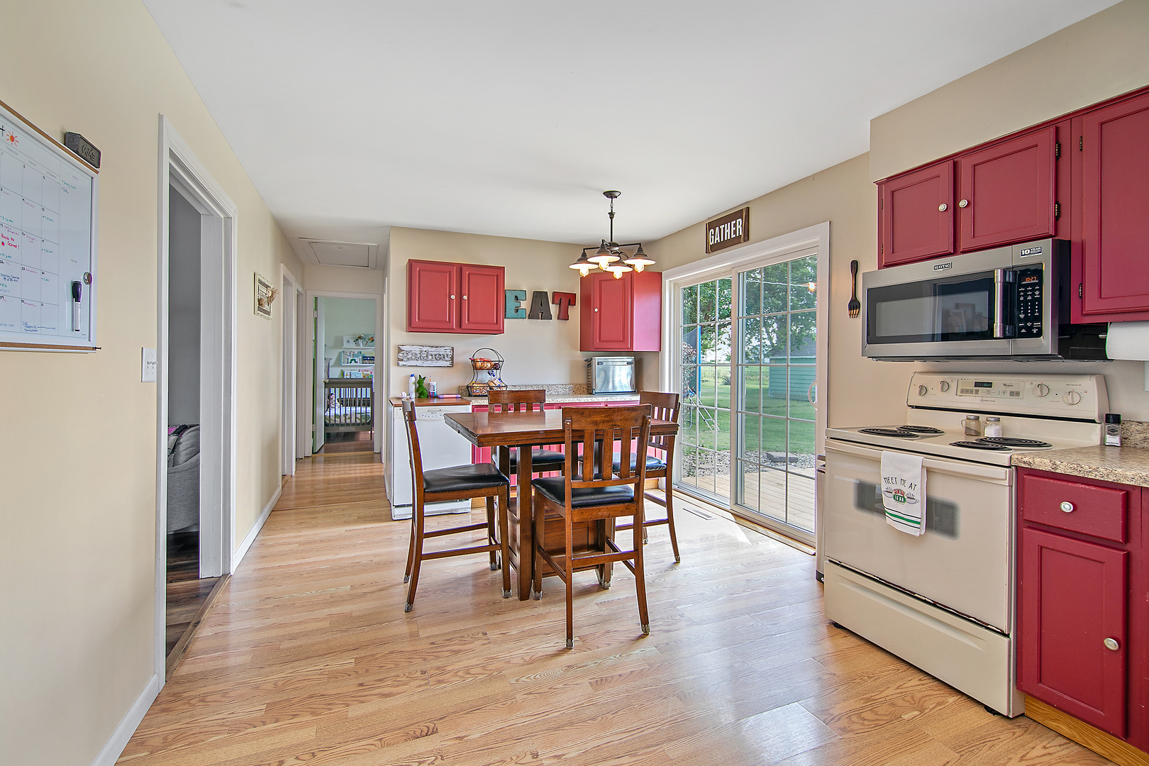 3494 El Paso Drive Kankakee, IL 60901 - Photo 9 of 20 a kitchen with stainless steel appliances a dining table chairs stove refrigerator and cabinets