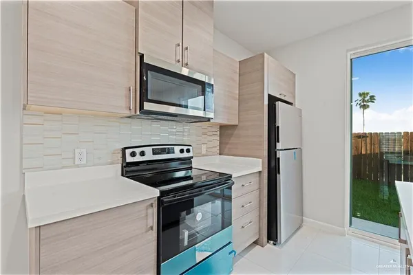 a kitchen with a stove microwave and refrigerator