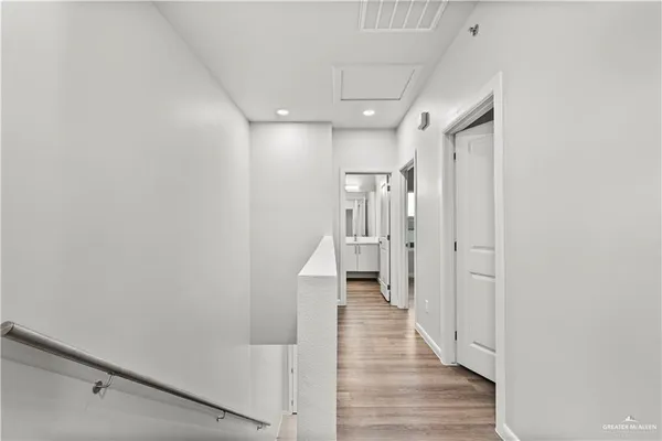 a view of a hallway with wooden floor