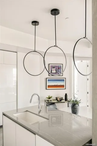 a kitchen with stainless steel appliances granite countertop a sink a stove and a wooden floor