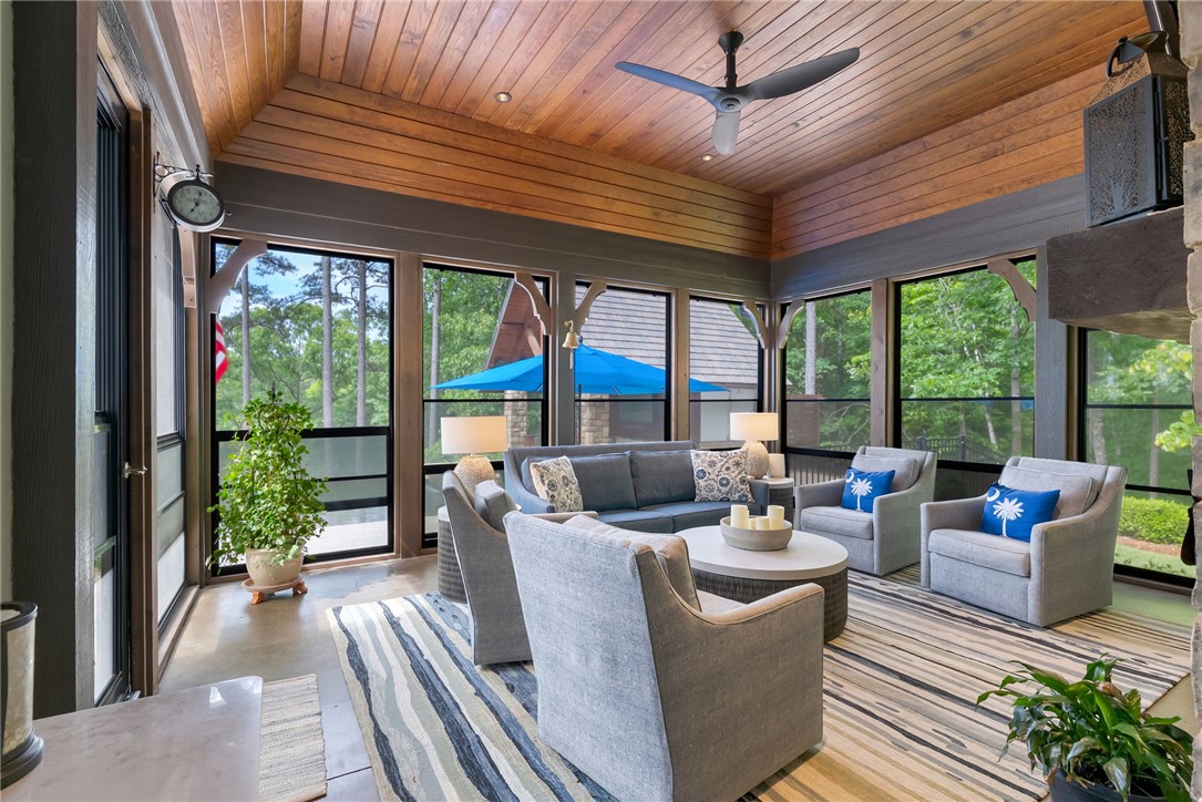 119 Drewberry Lane Sunset, SC 29685 - Photo 12 of 42 This inviting patio area features a warm wood ceiling and ample natural light, perfect for relaxation.