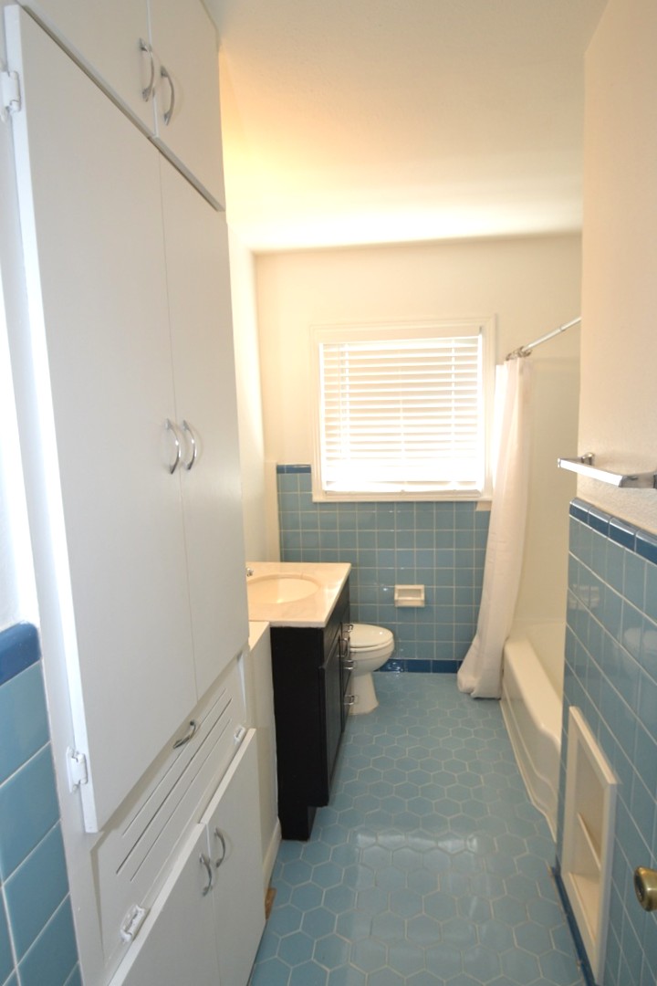 1211 Ridgemont Drive Austin, TX 78723 - Photo 14 of 28 a bathroom with a sink a toilet and vanity
