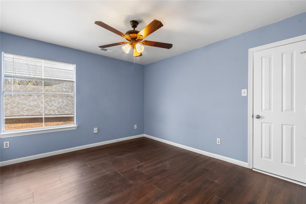 225 Freedom Court Rockwall, TX 75032 - Photo 22 of 28 an empty room with window and wooden floor