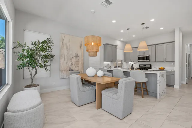 a living room with kitchen island furniture and a potted plant