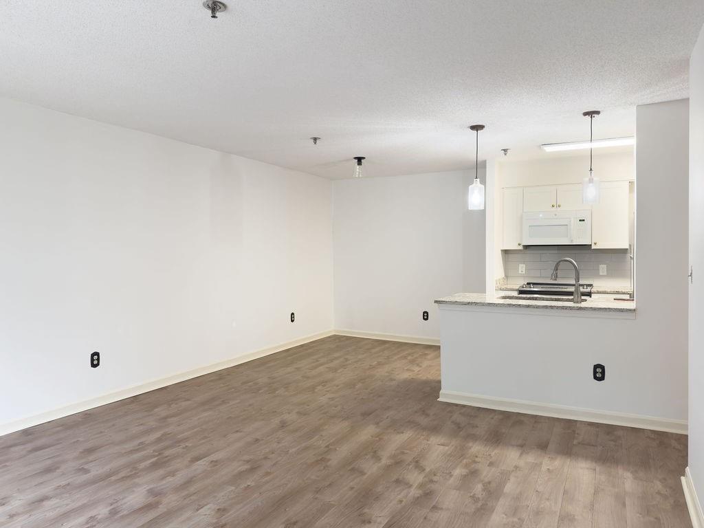 300 Johnson Ferry Road, Unit A305 Atlanta, GA 30328 - Photo 12 of 27 a view of kitchen with wooden floor