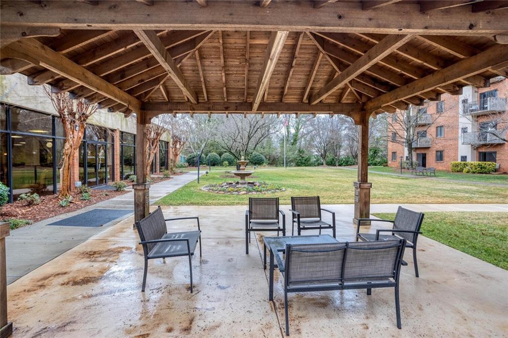 300 Johnson Ferry Road, Unit A305 Atlanta, GA 30328 - Photo 23 of 27 a view of a patio with a table and chairs