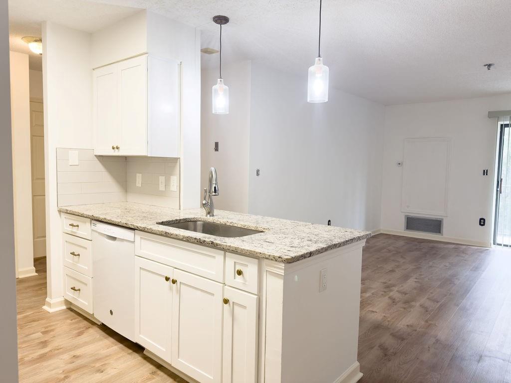 300 Johnson Ferry Road, Unit A305 Atlanta, GA 30328 - Photo 9 of 27 a bathroom with a granite countertop sink and a mirror