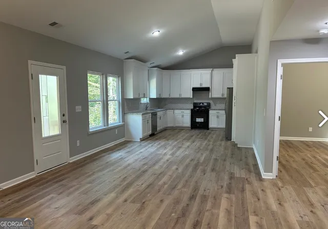 a view of kitchen with window and wooden floor