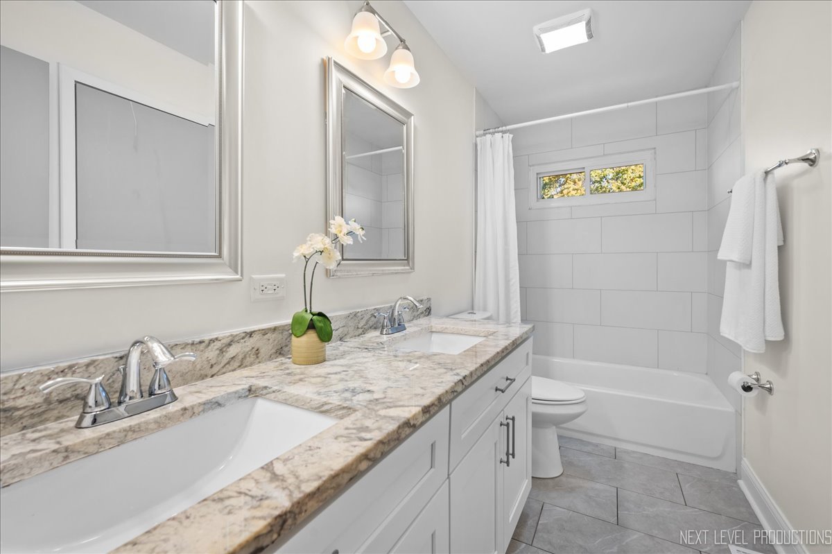 5628 Crestwood Road Matteson, IL 60443 - Photo 17 of 30 a bathroom with a granite countertop sink and a mirror