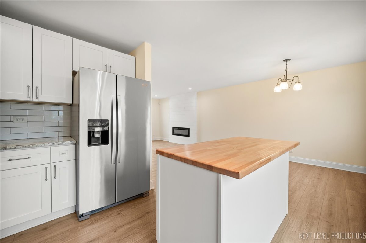 5628 Crestwood Road Matteson, IL 60443 - Photo 7 of 30 a kitchen with stainless steel appliances a refrigerator and wooden floor