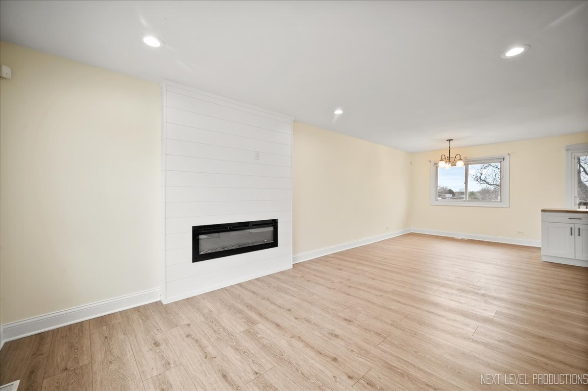5628 Crestwood Road Matteson, IL 60443 - Photo 9 of 30 an empty room with wooden floor and windows